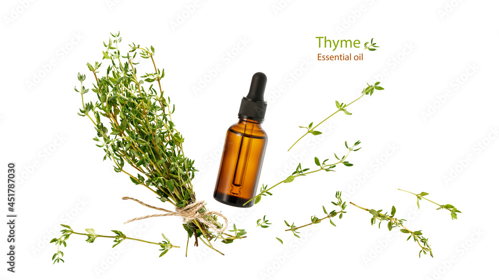 Thyme essential oil glass bottle,  aromatic herbs bunch and twigs flying isolated on white backgroun