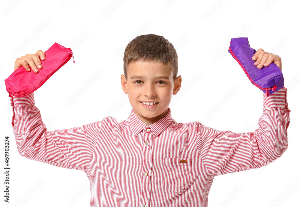 Little boy with pencil cases on white background