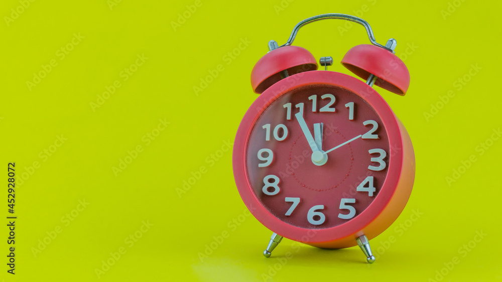 Red alarm clock on yellow background Before Twelve oClock on New Years Eve of Face of Beautiful ala