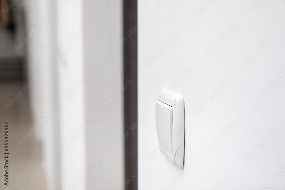 Modern light switch on white wall