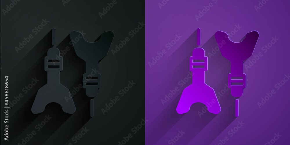 Paper cut Dart arrow icon isolated on black on purple background. Paper art style. Vector