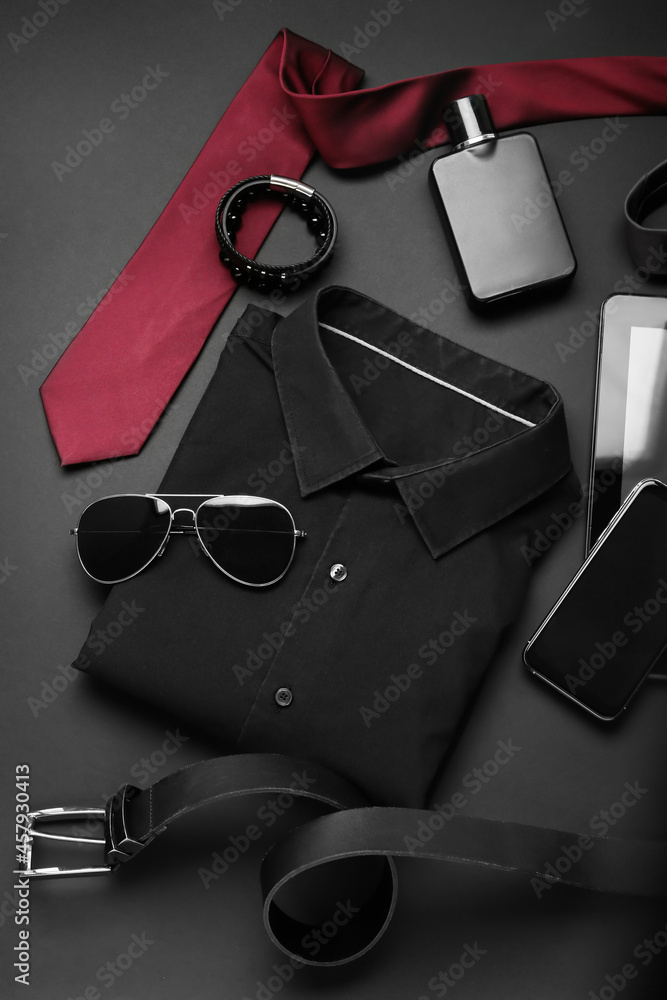 Stylish male clothes and accessories on dark background