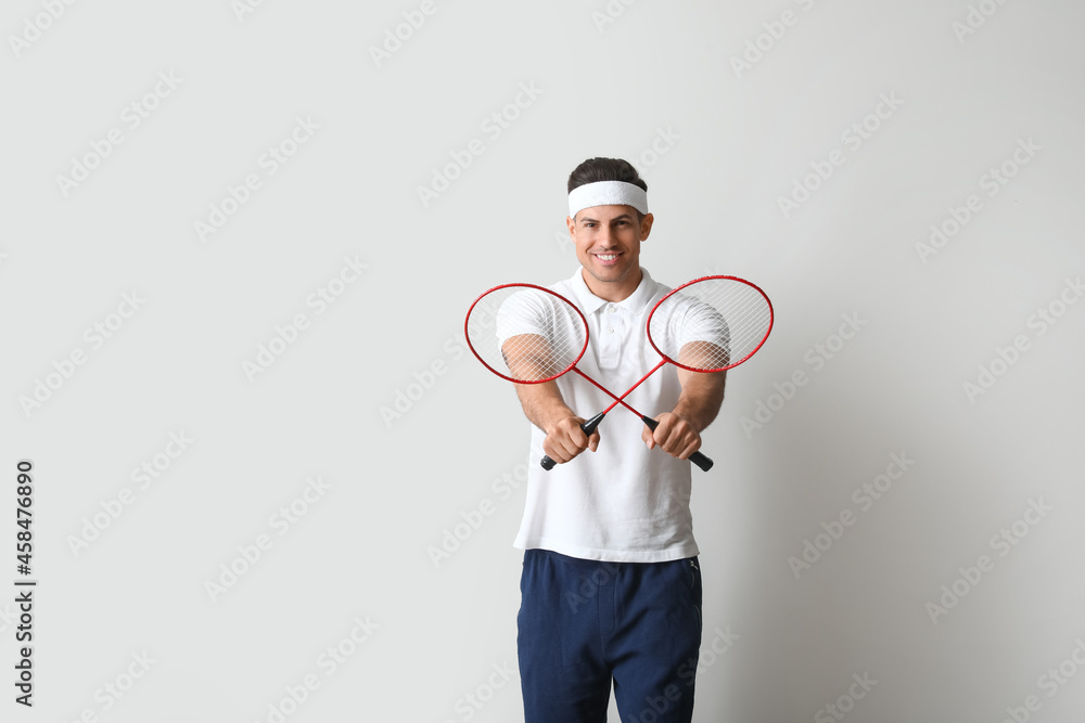 浅色背景的运动型男子羽毛球运动员