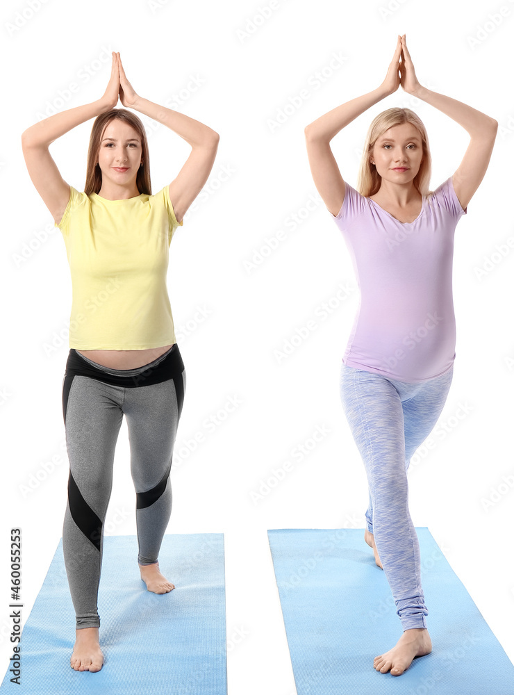 年轻孕妇在白色背景下练习瑜伽