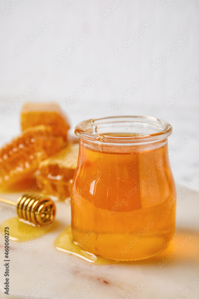 Jar with honey on table