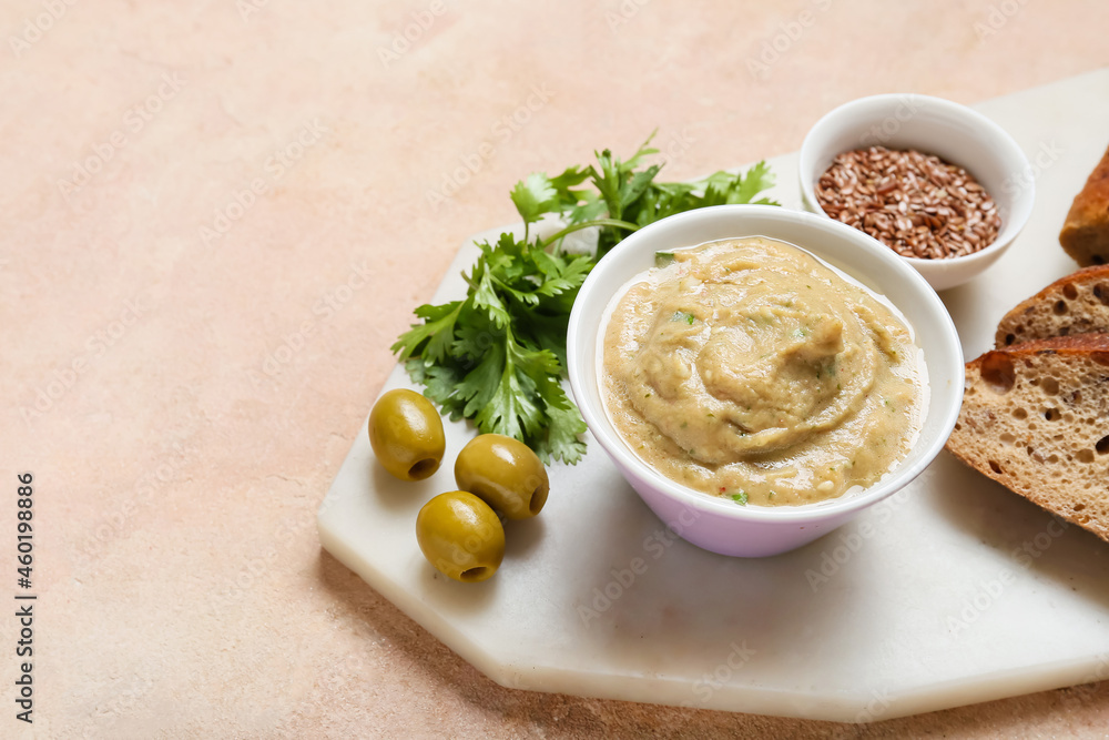 Bowl with tasty baba ghanoush, bread, olives and flax seeds on color background