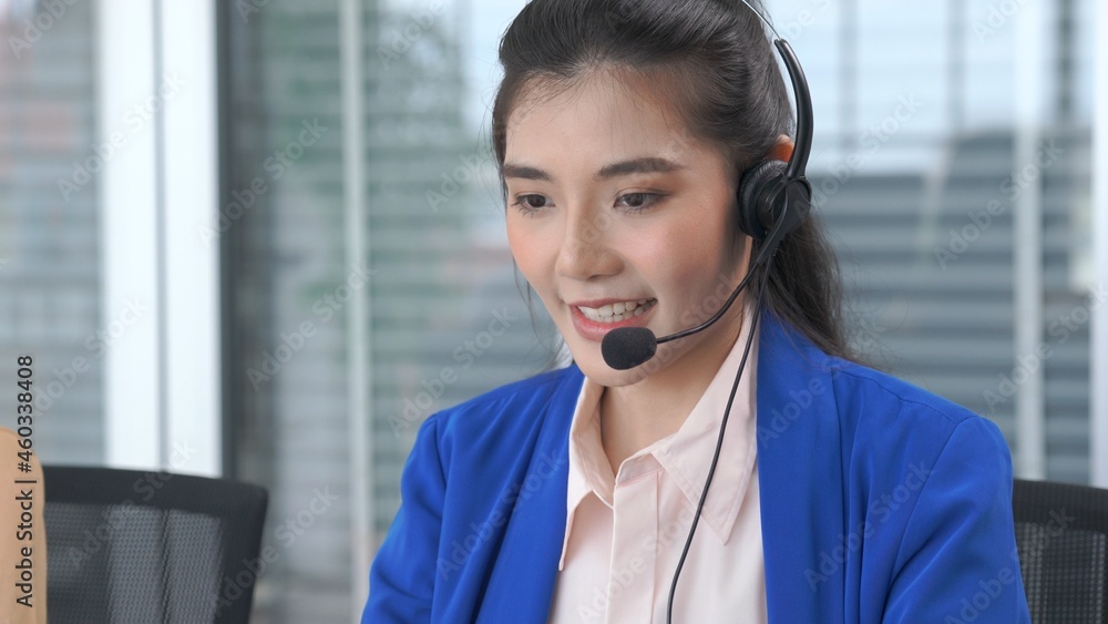Businesswoman wearing headset working actively in office . Call center, telemarketing, customer supp