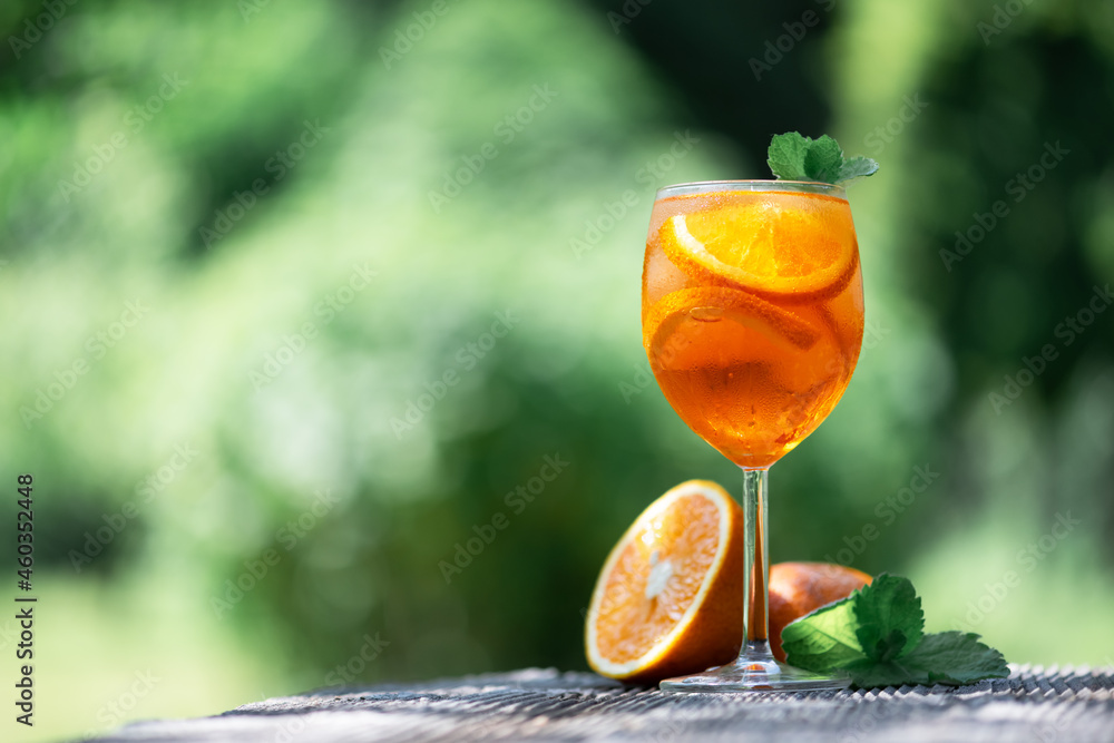 Aperol Spritz Aperitivo夏季鸡尾酒，原杯装，木质上有橙子和薄荷枝