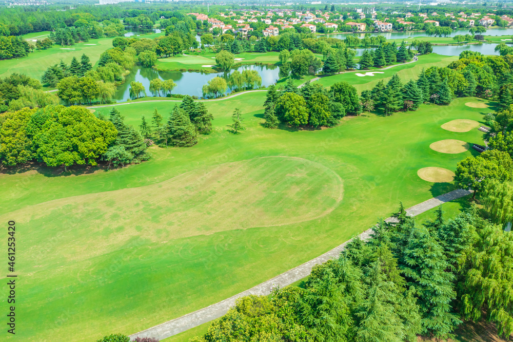 Aerial view of green lawn and forest on golf course.Green golf course scenery.