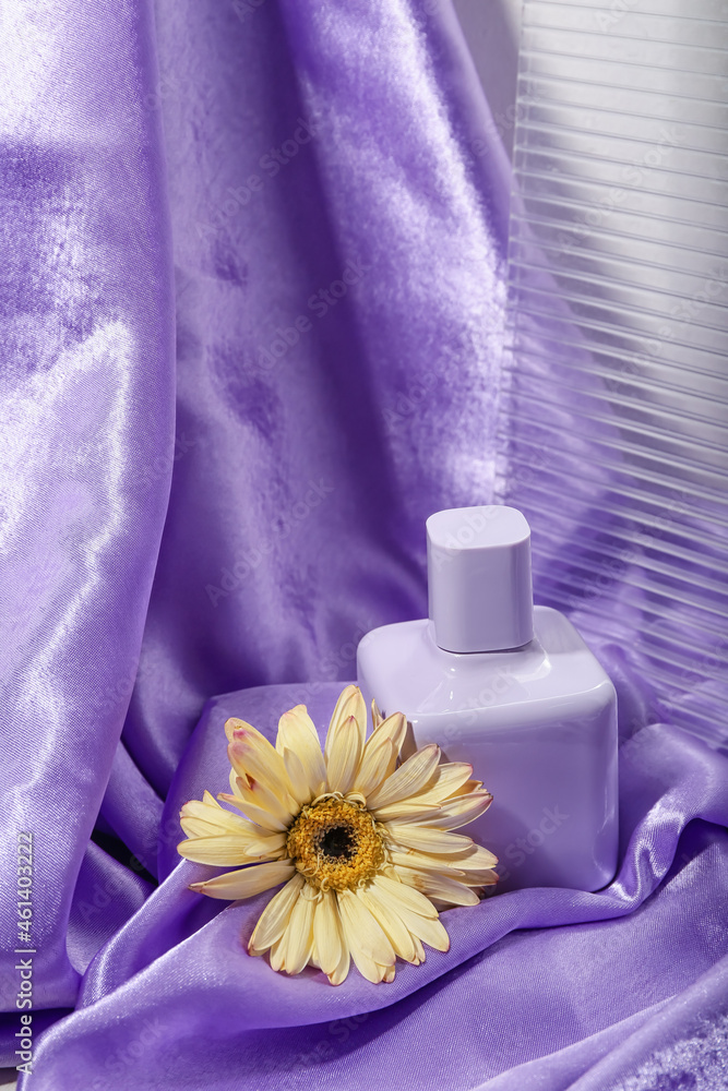 一瓶香水和非洲菊的彩色背景