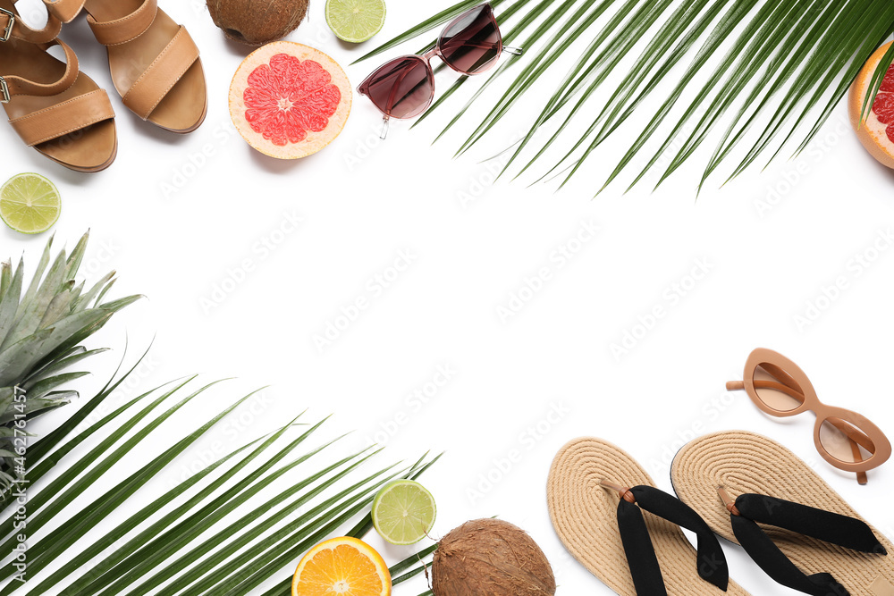 白色背景下由鞋子、太阳镜、水果和棕榈叶制成的框架