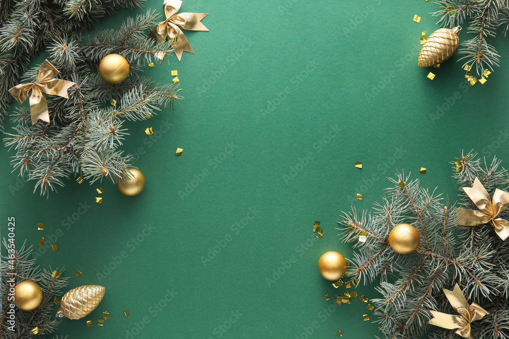 Fir branches and Christmas decorations on green background