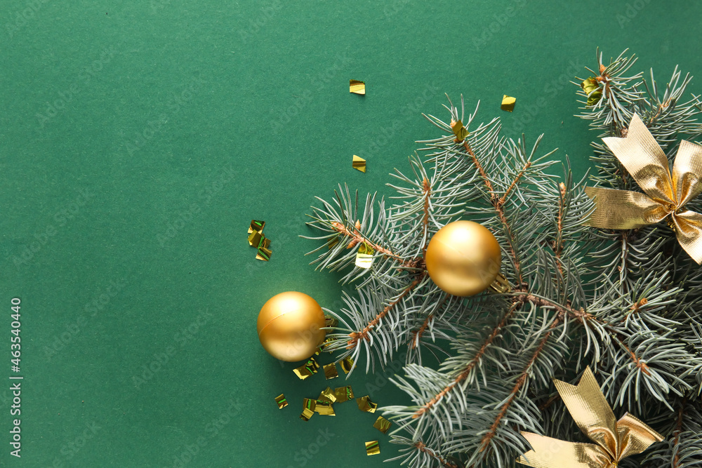 Fir branch and Christmas decorations on green background, closeup