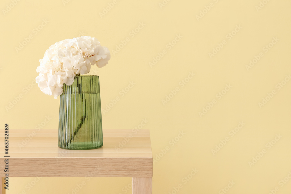 桌上时尚的绿色玻璃花瓶里的绣球花
