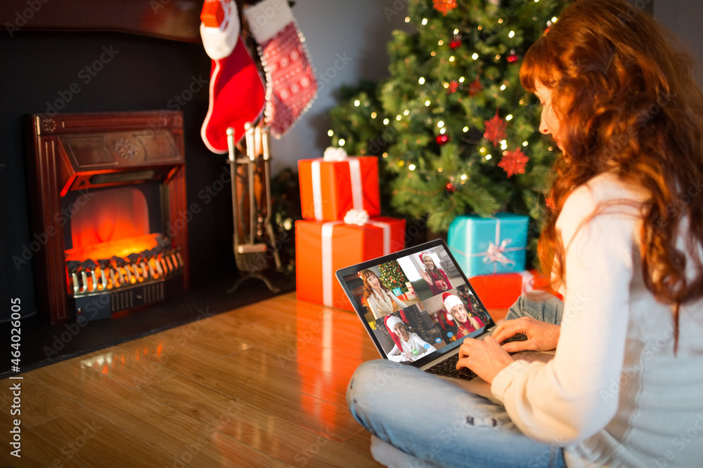 Caucasian woman on christmas laptop video call with four female friends