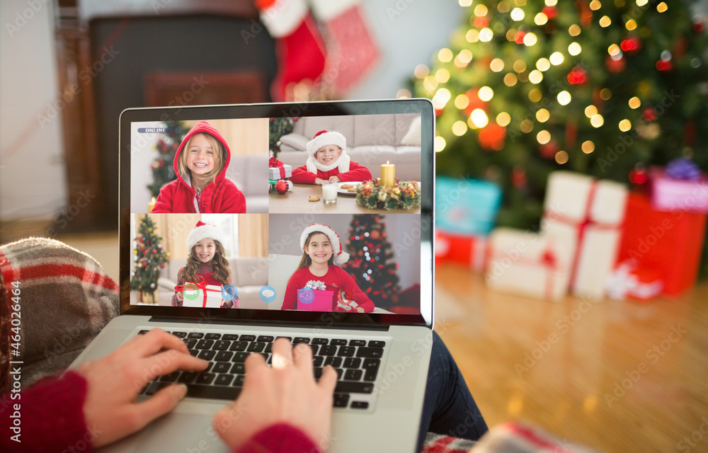 Caucasian woman making laptop christmas video call with four smiling girls