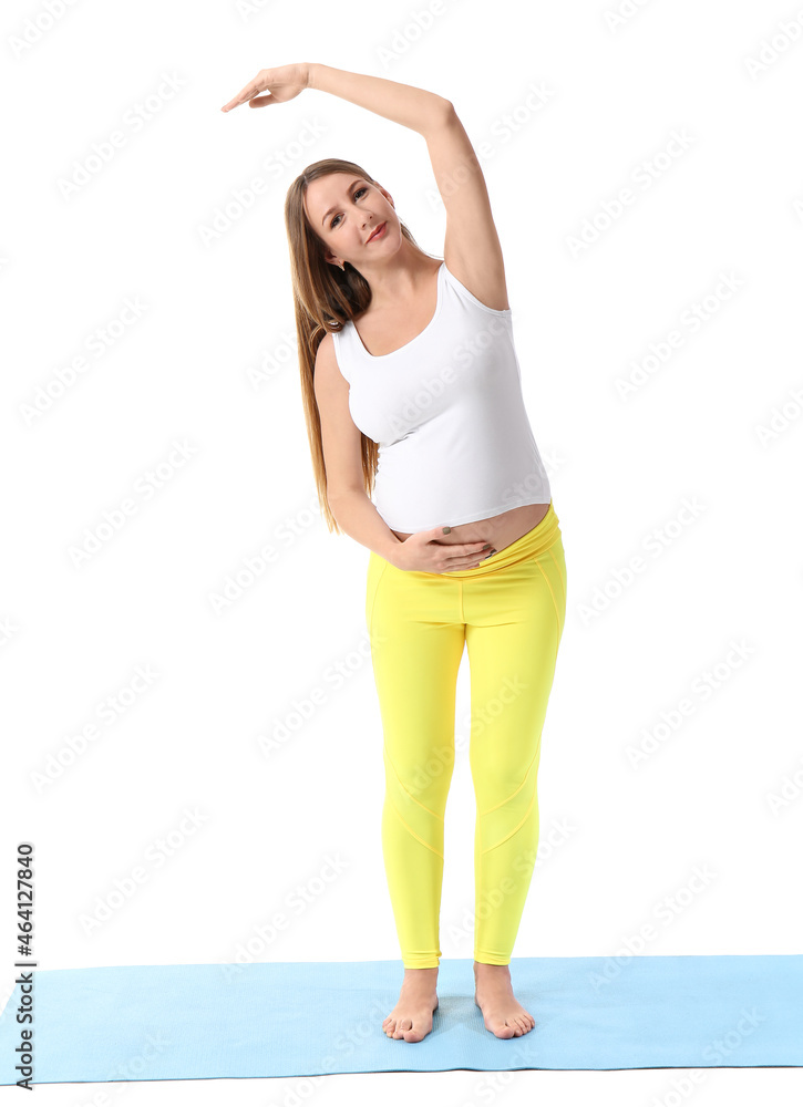 Young pregnant woman doing yoga on white background