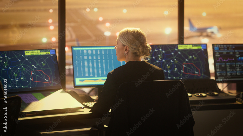 Portrait of Female Air Traffic Controller Working in Airport Tower. Office Room is Full of Desktop C
