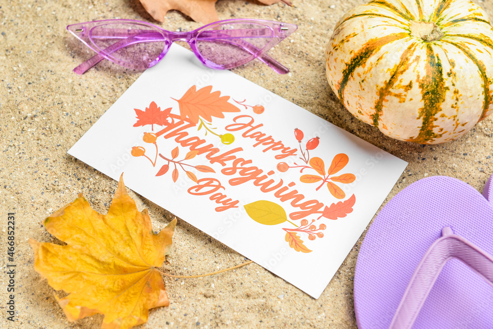 干树叶、太阳镜、南瓜、人字拖和纸卡片，上面写着沙滩上的快乐感恩节