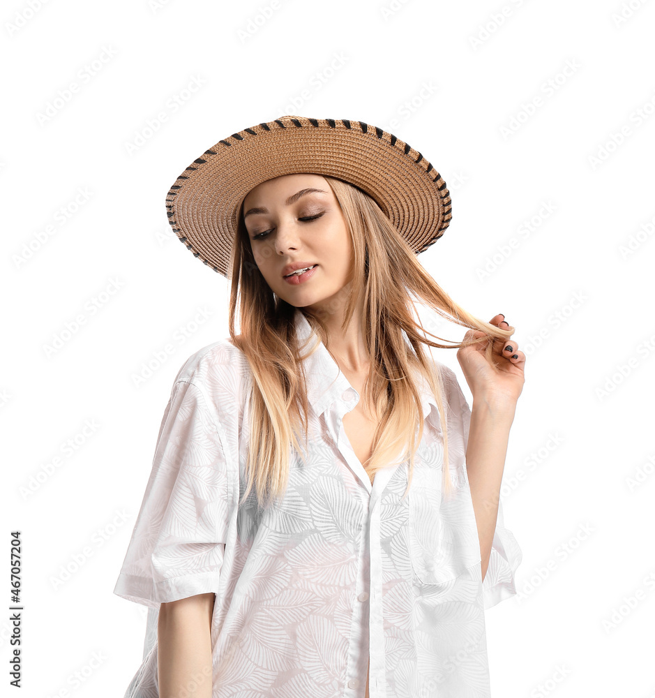 Young woman wearing wicker hat and touching her hair on white background