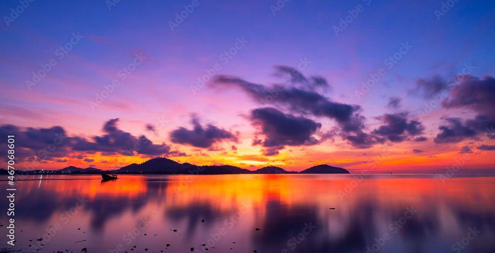 Beautiful motion blur long exposure sunset or sunrise with dramatic sky clouds over calm sea in trop