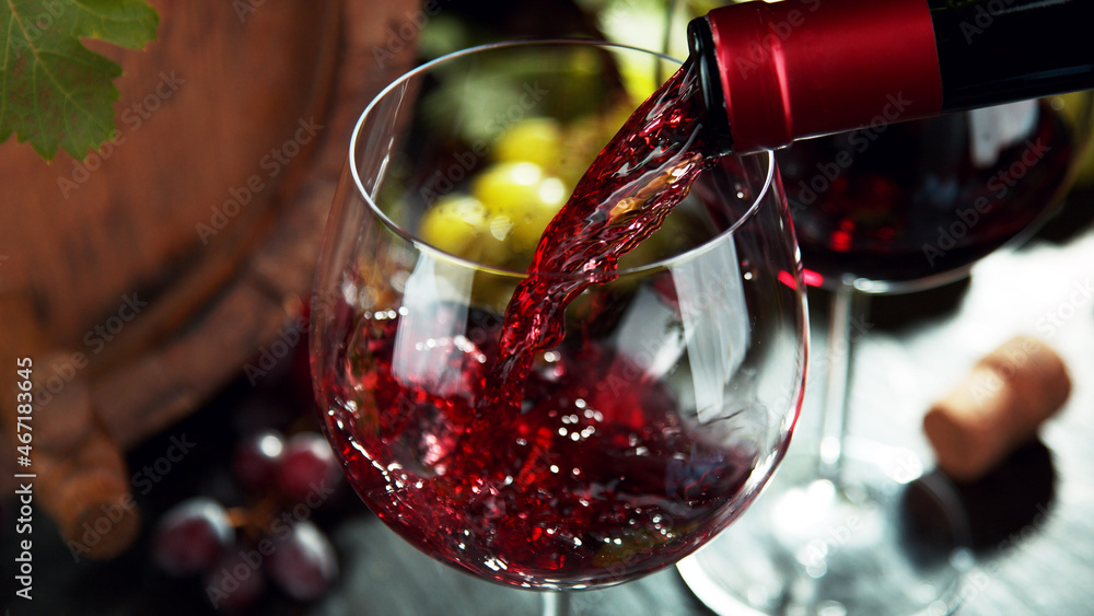 Macro shot of pouring red wine into glass.