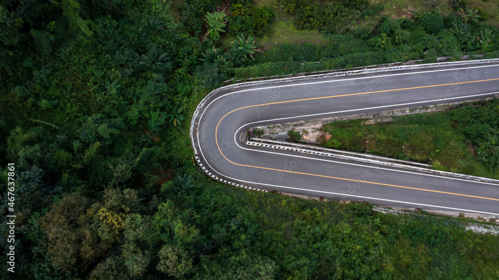 Aerial view asphalt road in mountain pass with green forest, Countryside road passing through the gr