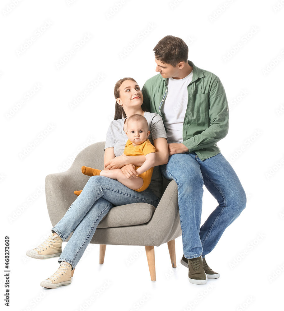 Young parents with little baby sitting in armchair on white background