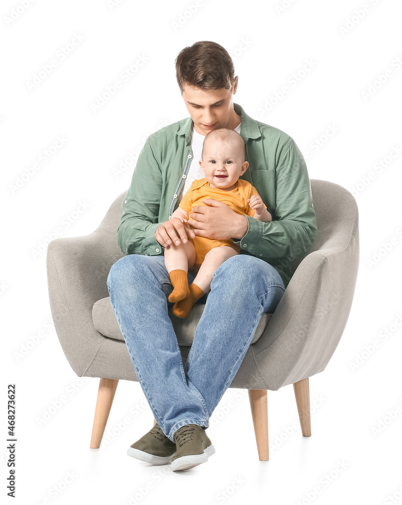 Young father with little baby sitting in armchair on white background