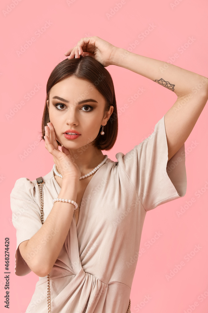 Portrait of fashionable woman with stylish accessories on color background