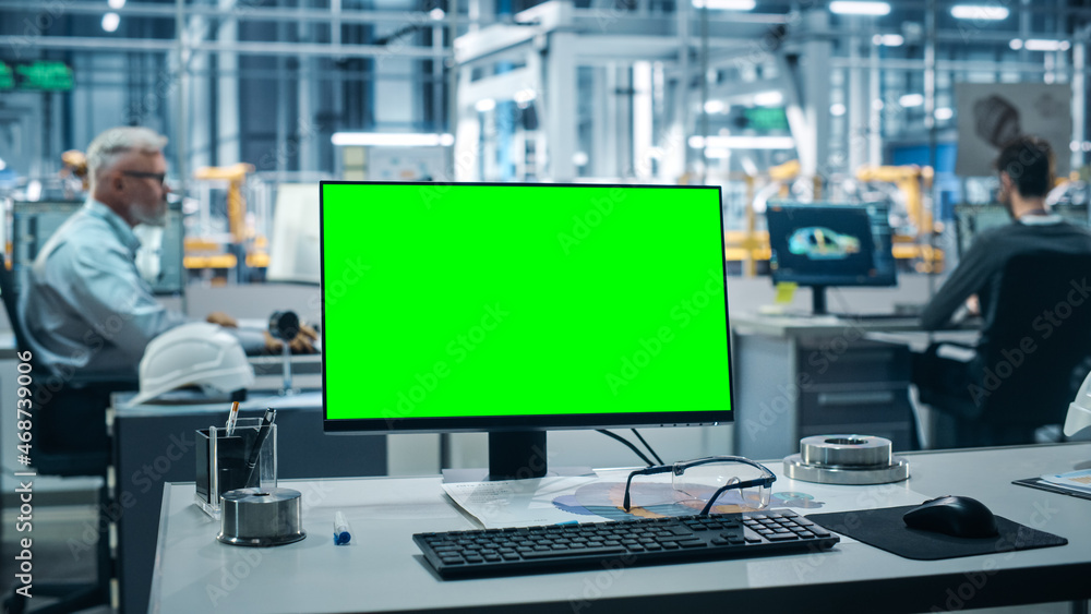 Car Factory: On the Desk Green Screen Chroma Key Computer. In Background Diverse Team of Engineers W