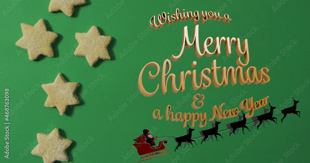 绿色背景下的圣诞老人雪橇和雪橇上的祝你圣诞快乐的文字图片