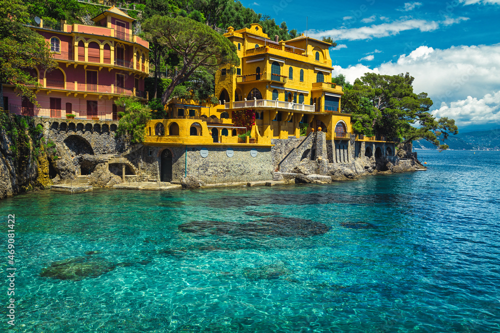 Colorful waterfront houses with beautiful azure blue beach, Portofino, Italy