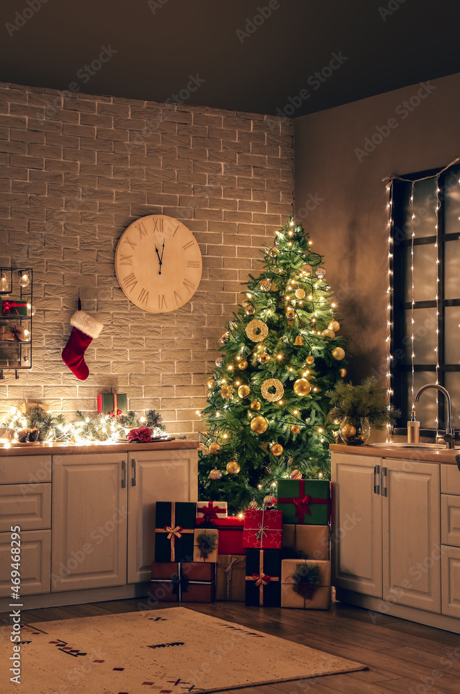 Interior of kitchen with stylish decor, Christmas tree and gift boxes