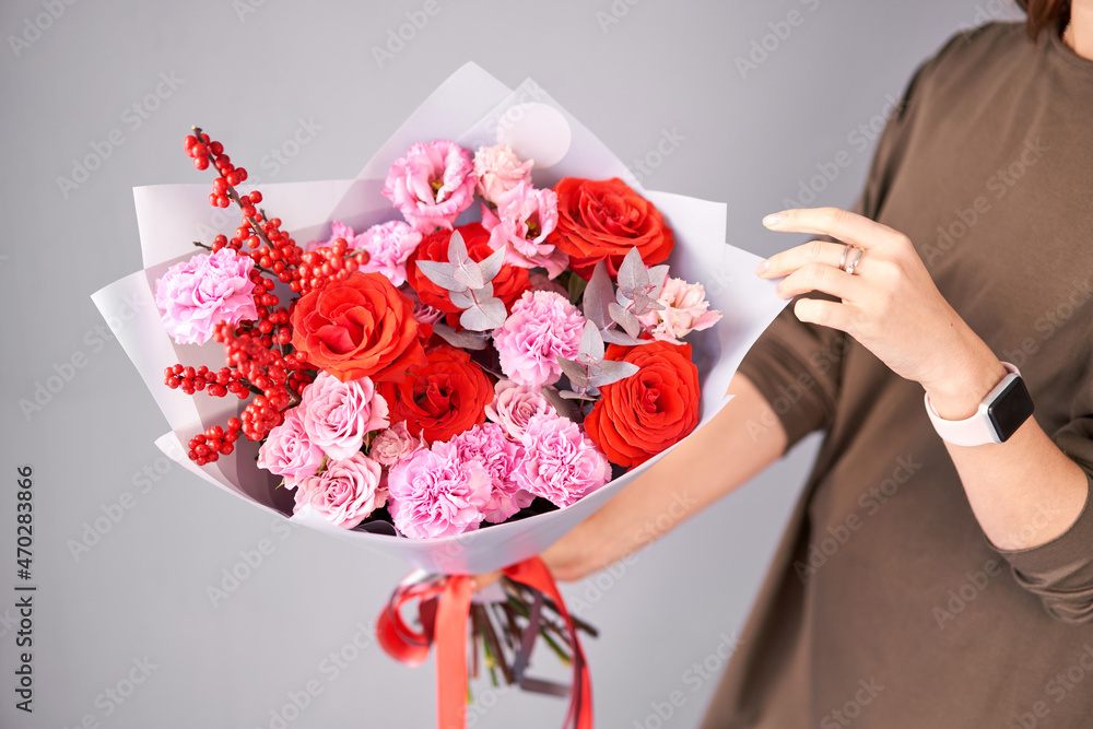 女人手中的一束美丽的混合花。漂亮的新鲜花束。小花店和Flow