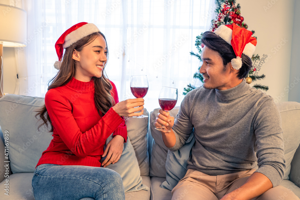 Asian young happy couple celebrate christmas party together in house. 