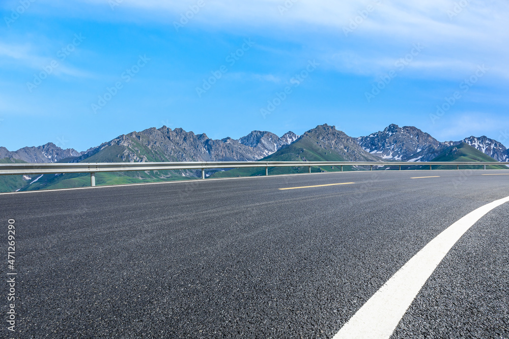 蓝天下的沥青路和山。公路和山的背景。