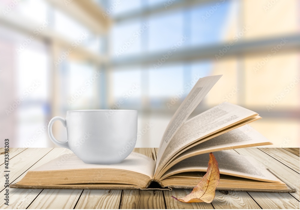 season, leisure and objects concept, a cup of coffee, book, autumn leaves