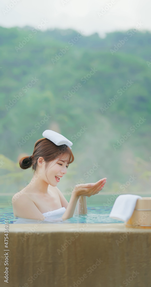 Woman scoop up hot spring