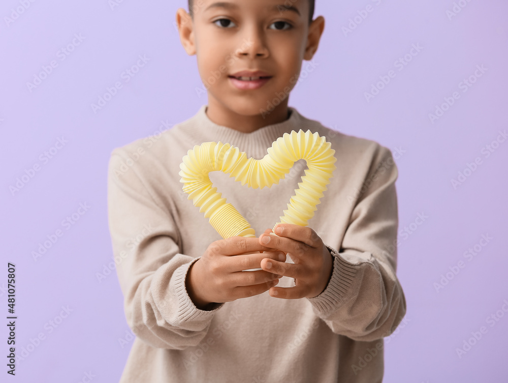 一个非洲裔美国小男孩，淡紫色背景的黄色Pop Tube