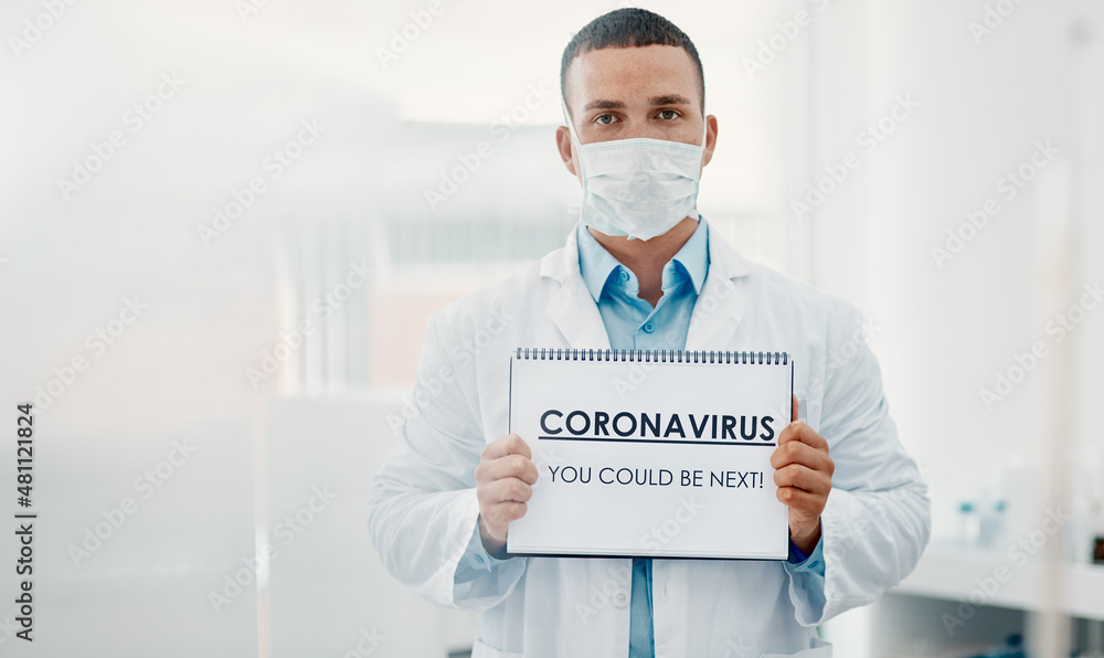我们都处于危险之中。一名科学家举着一块写有冠状病毒的牌子的照片——你可能是下一个