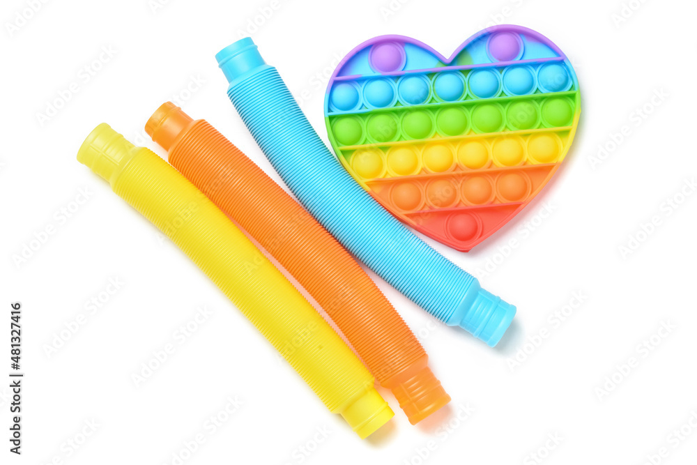 彩色Pop Tubes和白色背景的Pop-it坐立不安玩具