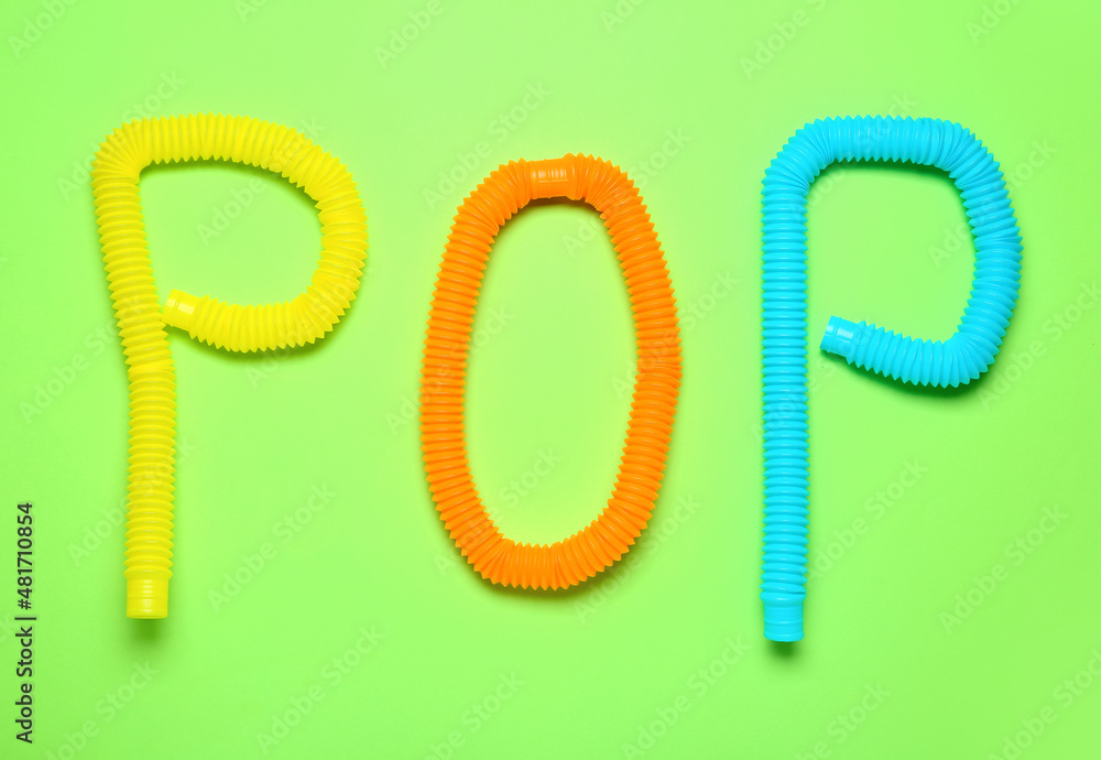 Composition with Pop Tubes on green background