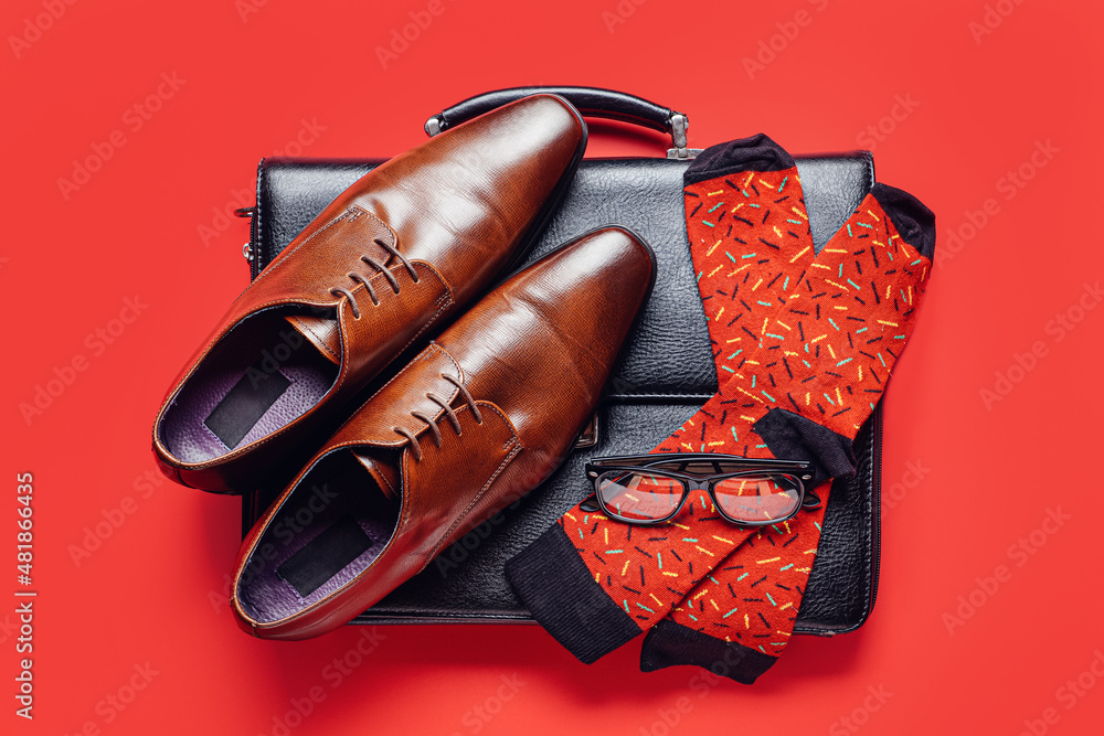 Accessories of businessman and socks on color background