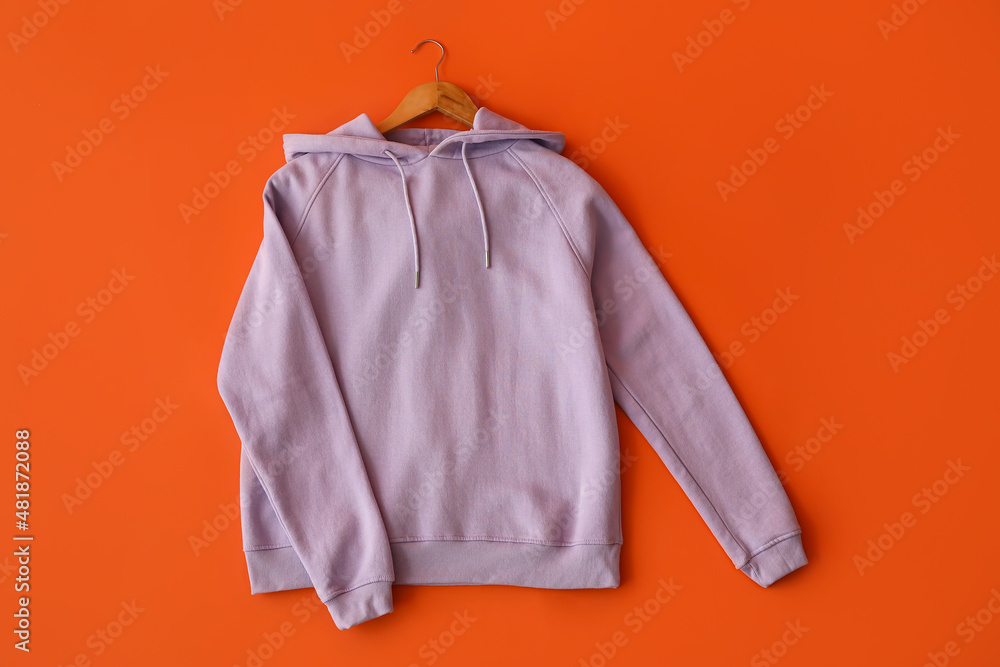 Stylish lilac hoodie on red background