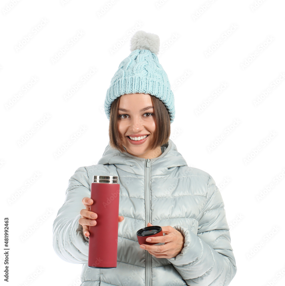 Beautiful young woman with thermos isolated on white