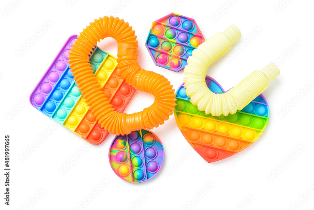 彩色Pop Tubes和白色背景上的Pop-it坐立不安的玩具