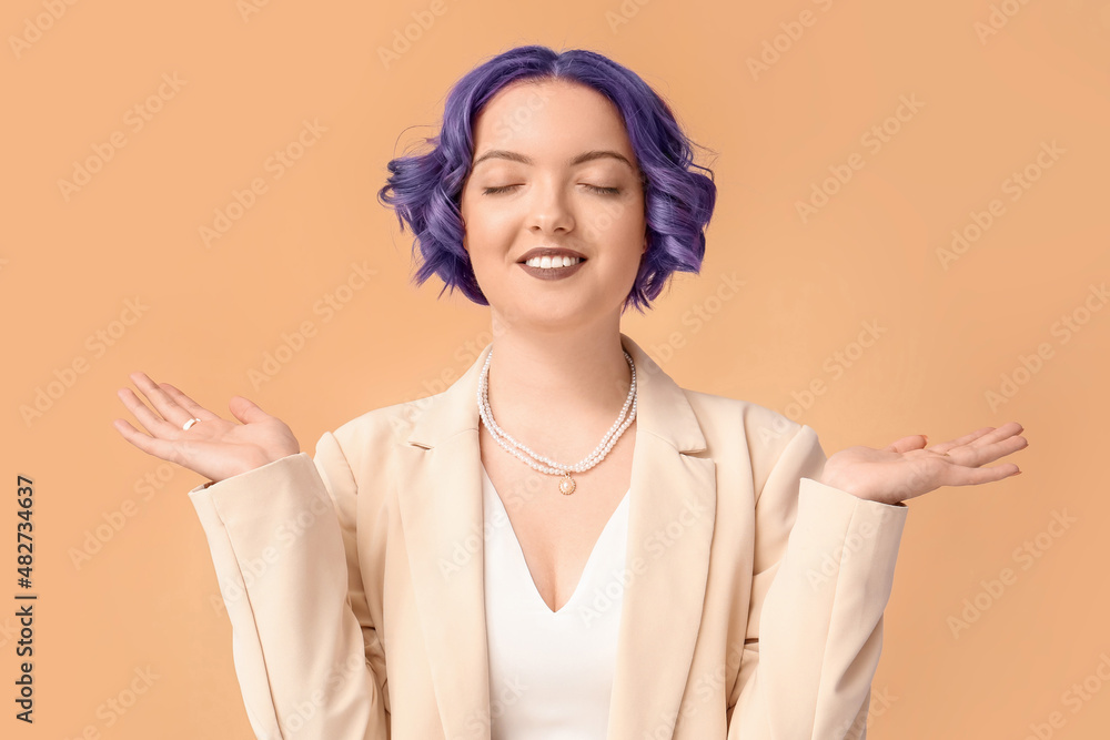 Beautiful young woman with violet hair on color background. Very Peri - color of year 2022
