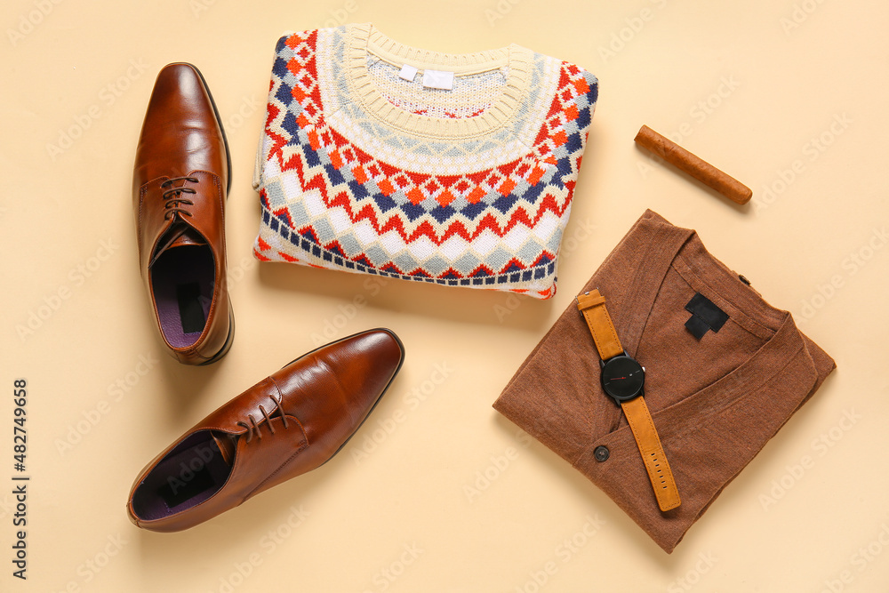 男毛衣、鞋、手表和彩色背景雪茄