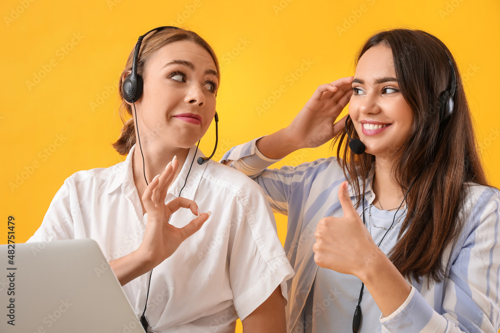 戴着耳机、带着彩色背景笔记本电脑的快乐年轻女性